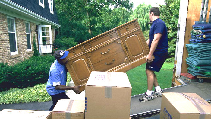 Movers moving dresser